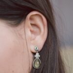 woman silver-colored earring