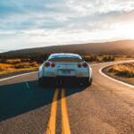 silver sports coupe on asphalt road