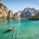 three brown wooden boat on blue lake water taken at daytime